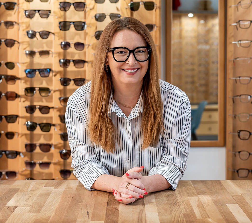 Lydia Baier lehnt auf einem Tisch in Ihrem Geschäft W&W Optik in Herzogenaurach